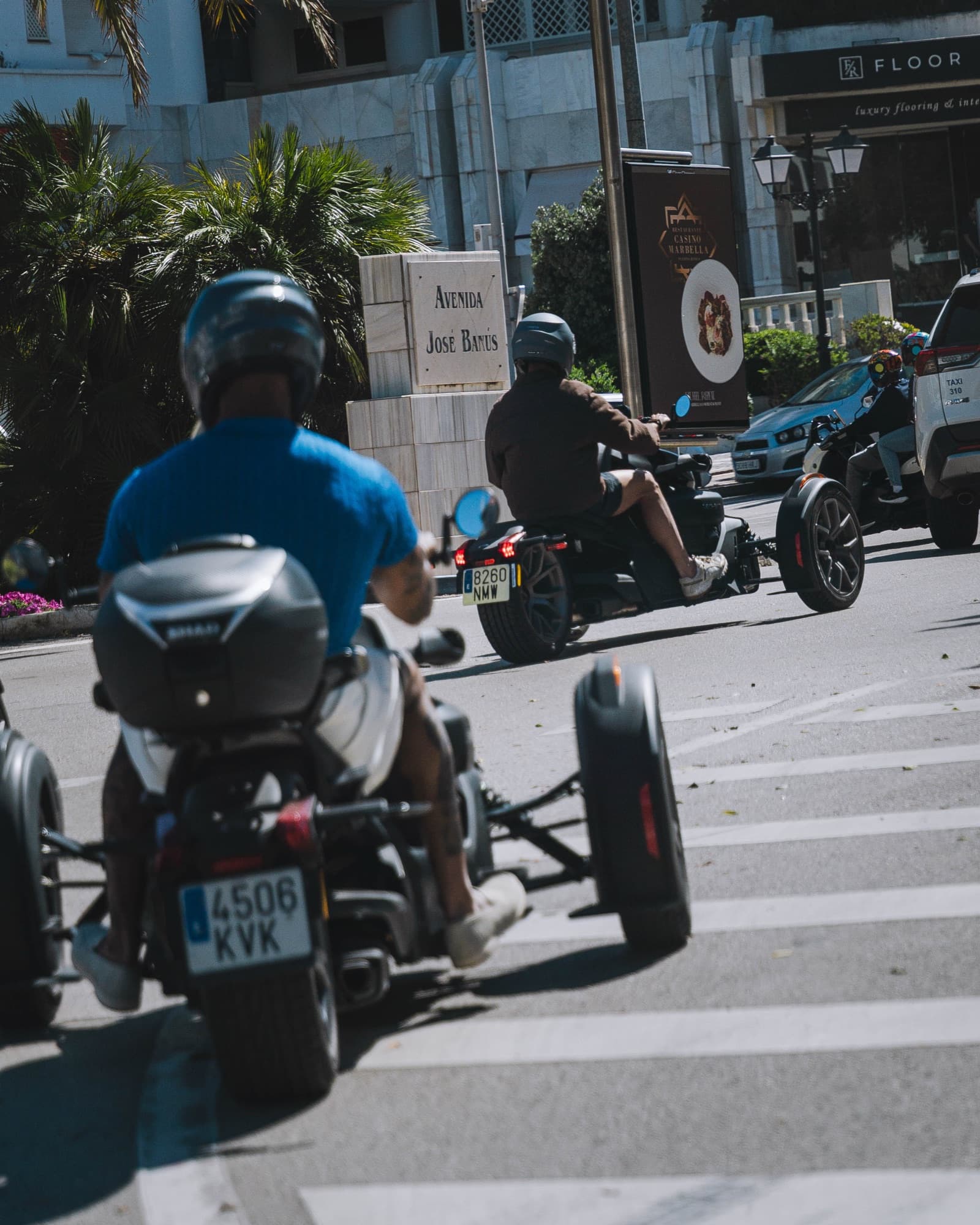 Couple riding a Can-Am Ryker together on the coast road
